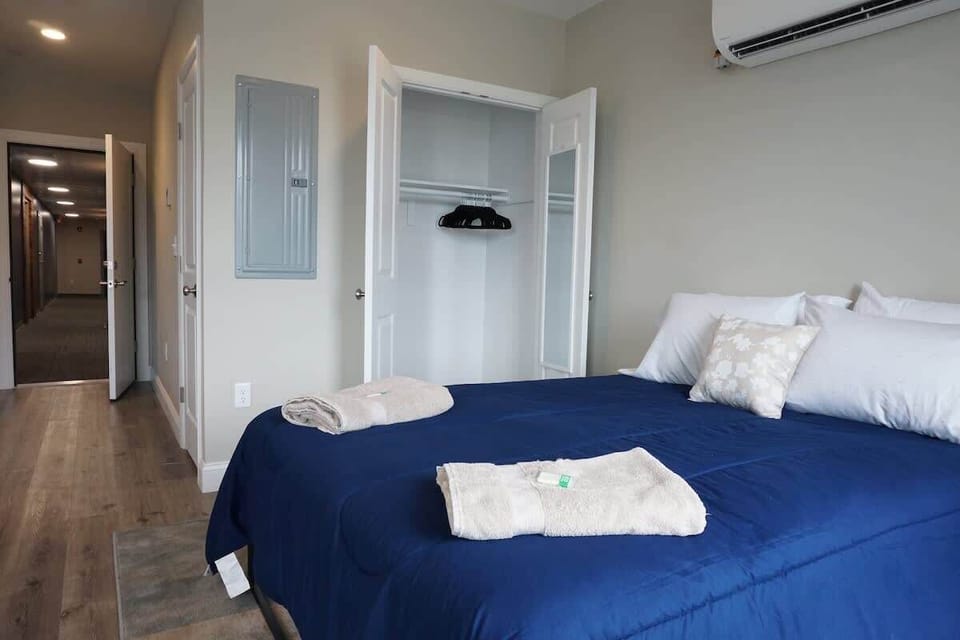 Bedroom with a queen-sized bed and a closet.