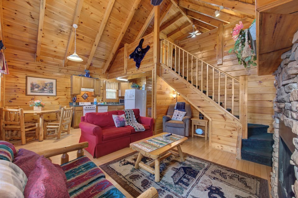 Cozy up in this charming log cabin with soaring ceilings, rustic furnishings, and warm wood throughout your mountain retreat.