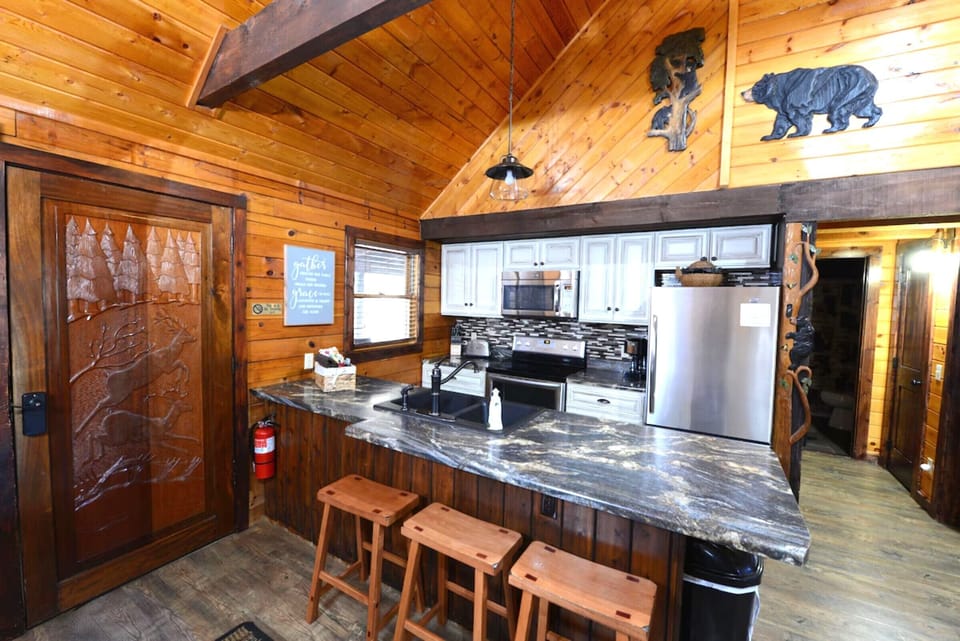 Your rustic kitchen features granite counters, stainless appliances, and charming woodland décor—perfect for preparing mountain meals together.
