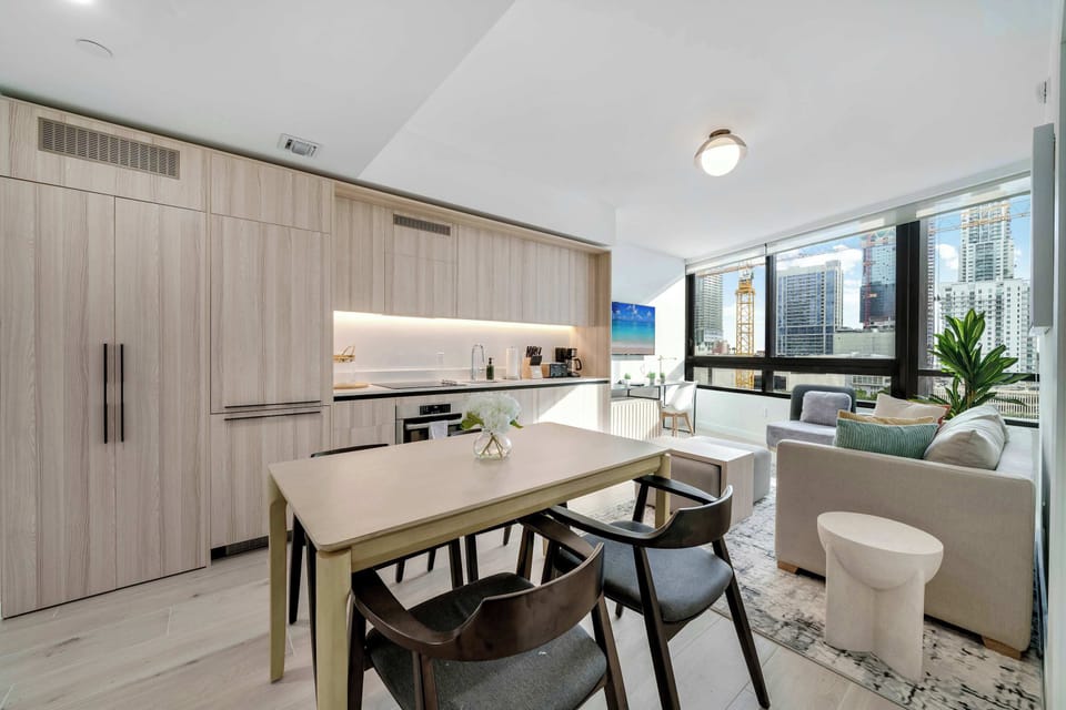 Enjoy a bright and airy atmosphere in our unified living space. Whether you’re cooking in the modern kitchen, dining at the sleek table, or relaxing on the sofa bed, you’ll be surrounded by beautiful city views
