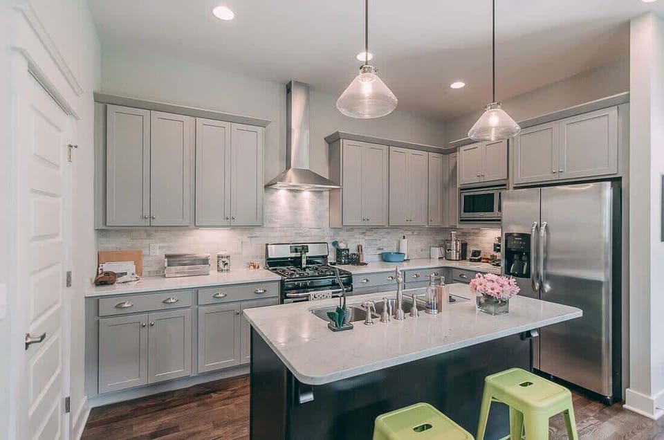 Kitchen - Has lots of cookware and dishes, microwave, gas stove, dishwasher and a standard coffee pot with coffee, creamer and sugar to get you started. There are 6 green stools as well.