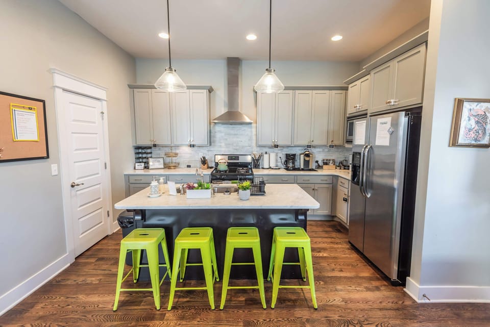 Kitchen is stocked with all your appliances, dishes and cookware needs. There are 6 green stools for added seating in addition to the dining area.
