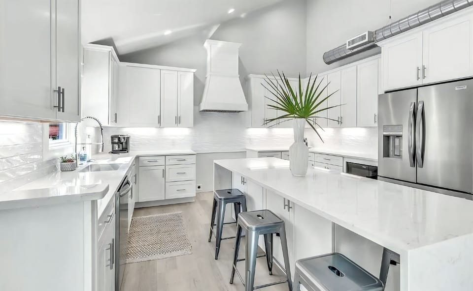 Family cooking and conversation unfold comfortably in this bright space.