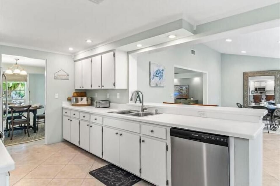 Your spacious kitchen awaits with gleaming white cabinets, granite counters, and stainless steel appliances for memorable vacation meals.