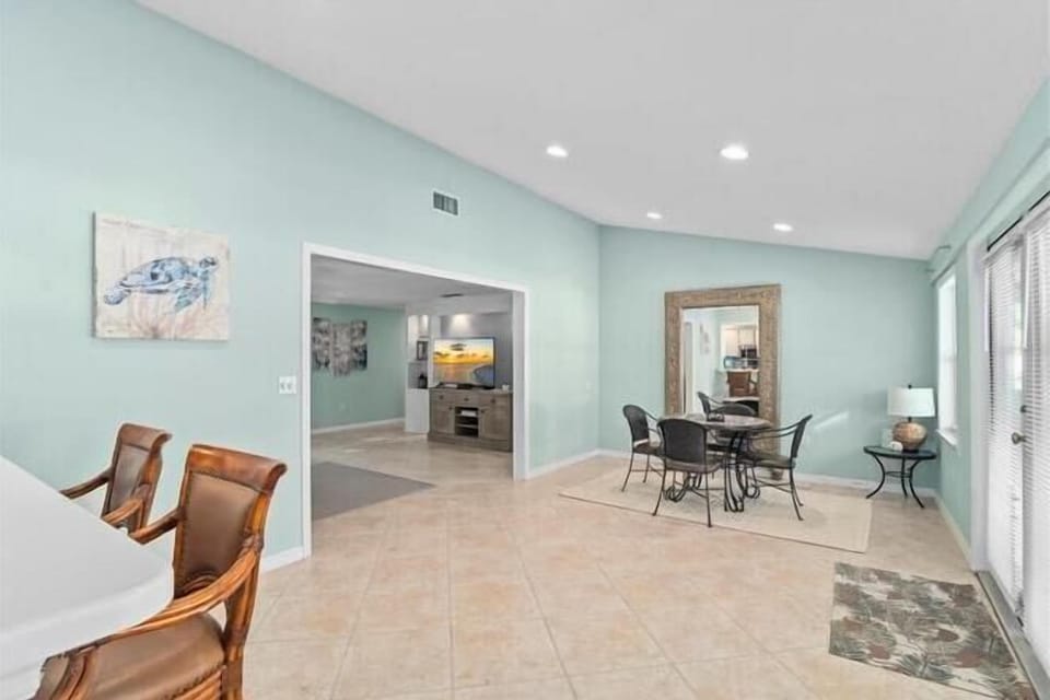 Your bright, open living space features soothing mint walls and elegant tile floors, creating a peaceful retreat for relaxation and dining.