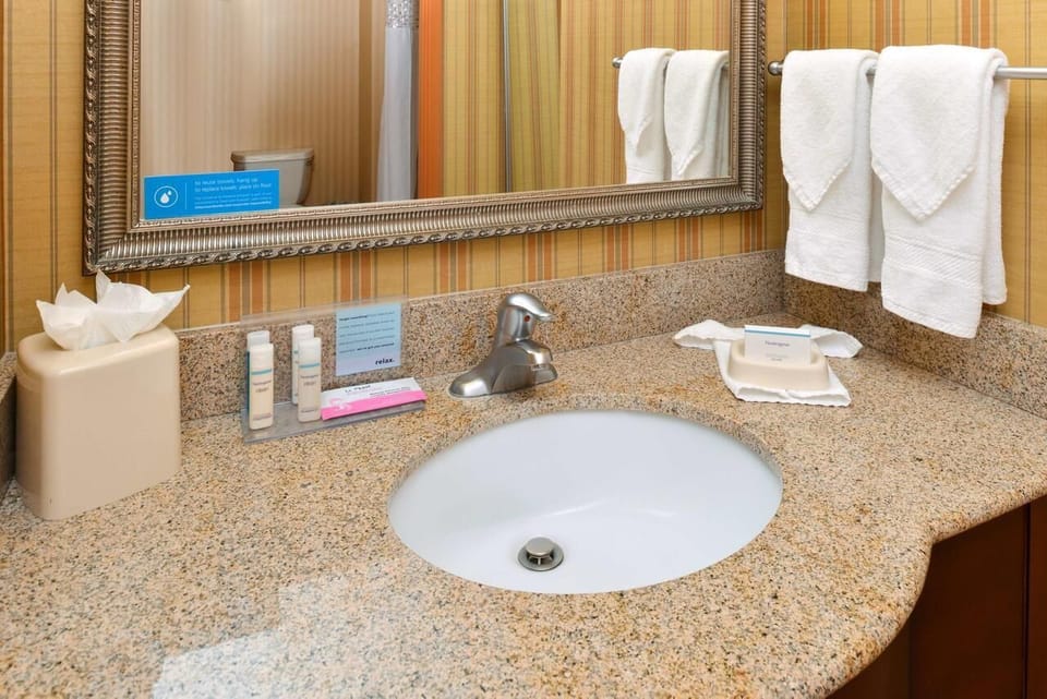 Refresh at the granite vanity with plush towels waiting.