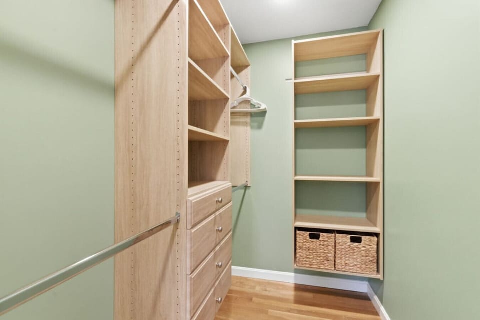 Large walk-in closet with shelves and hanging space