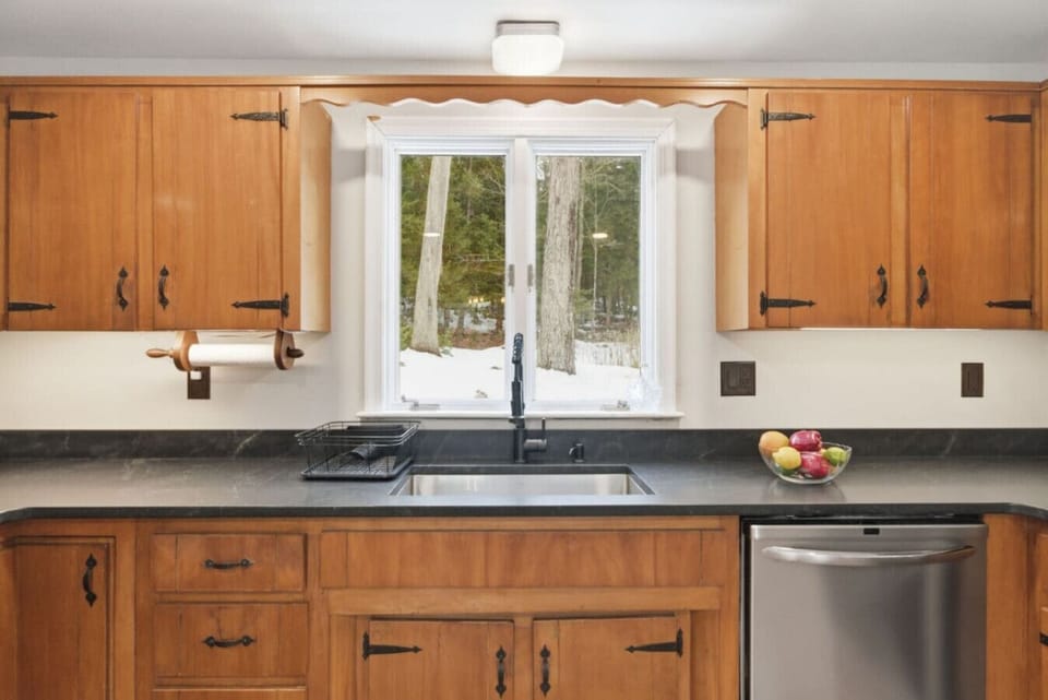 Bright kitchen workspace with large window and double sink