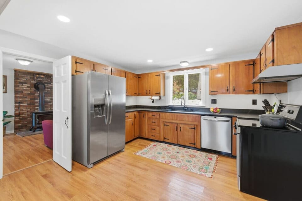 Fully equipped kitchen with stainless appliances and ample cabinetry