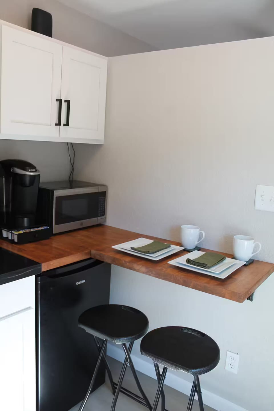 Fold away counter for prep space and meals plus a cabinet of dishes and utensils