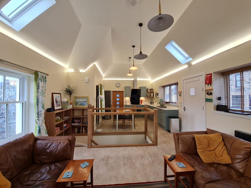 Open plan lounge, kitchen and dining area with feature oak staircase