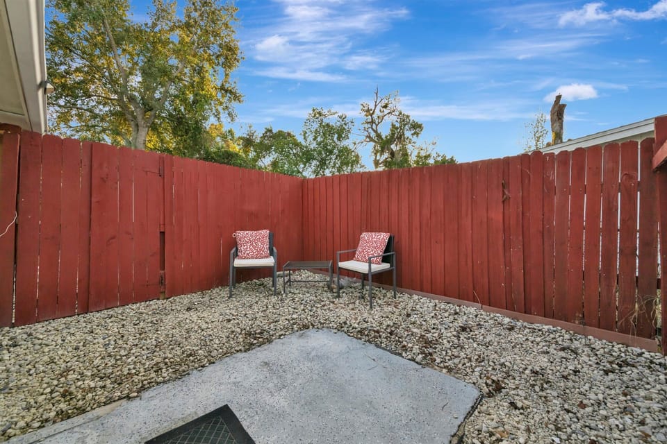 Quiet backyard seating surrounded by privacy fencing