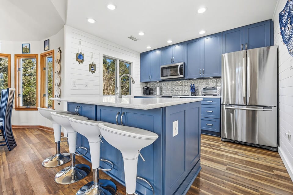 The fully equipped kitchen features modern appliances, ample counter space, and everything needed to prepare meals at home.