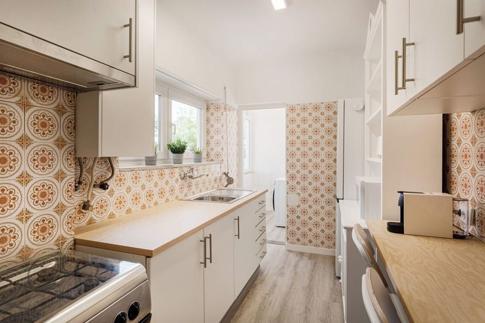 The kitchen keeps its charming retro tiles but is fully modernized for everyday cooking.