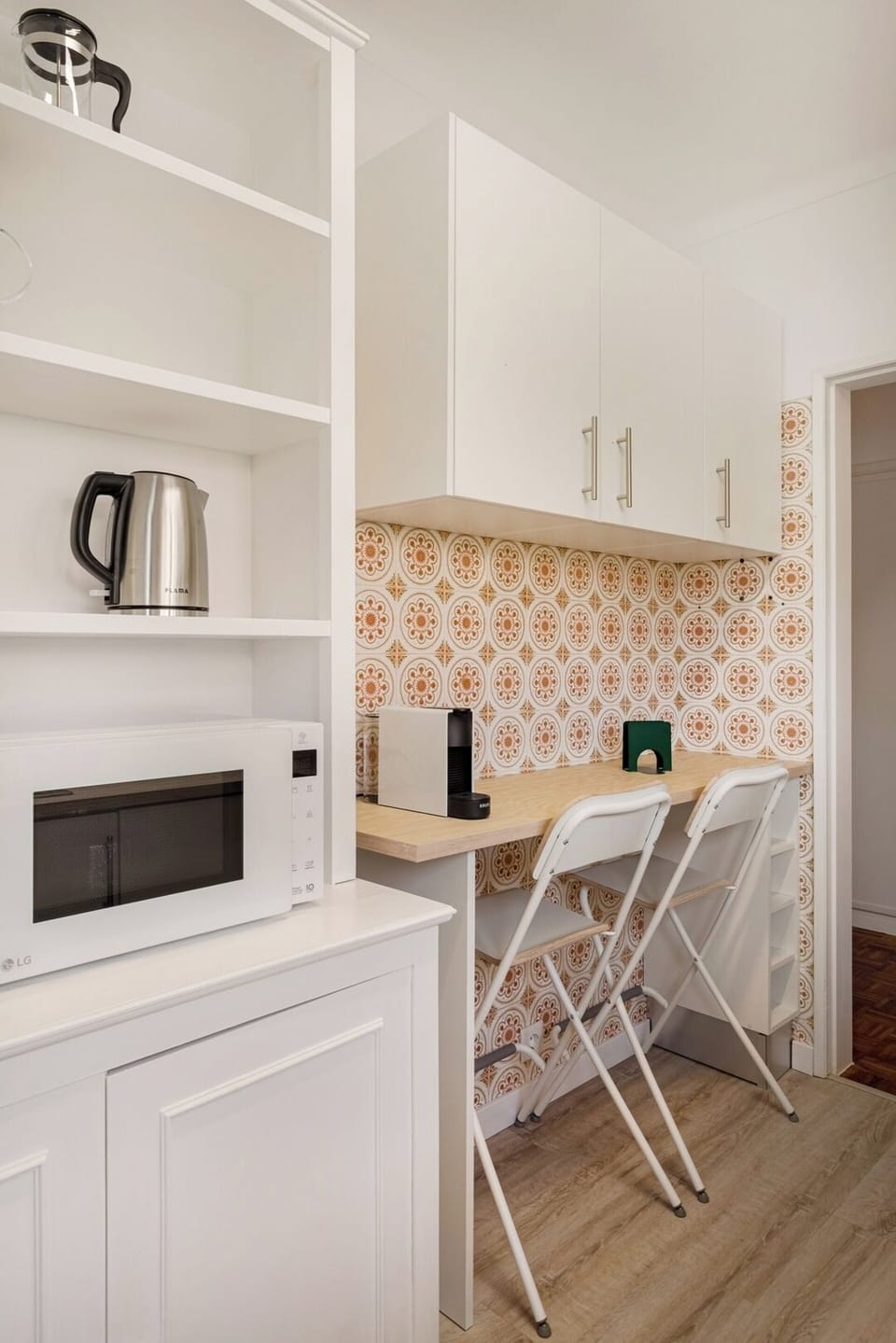 The kitchen keeps its charming retro tiles but is fully modernized for everyday cooking.