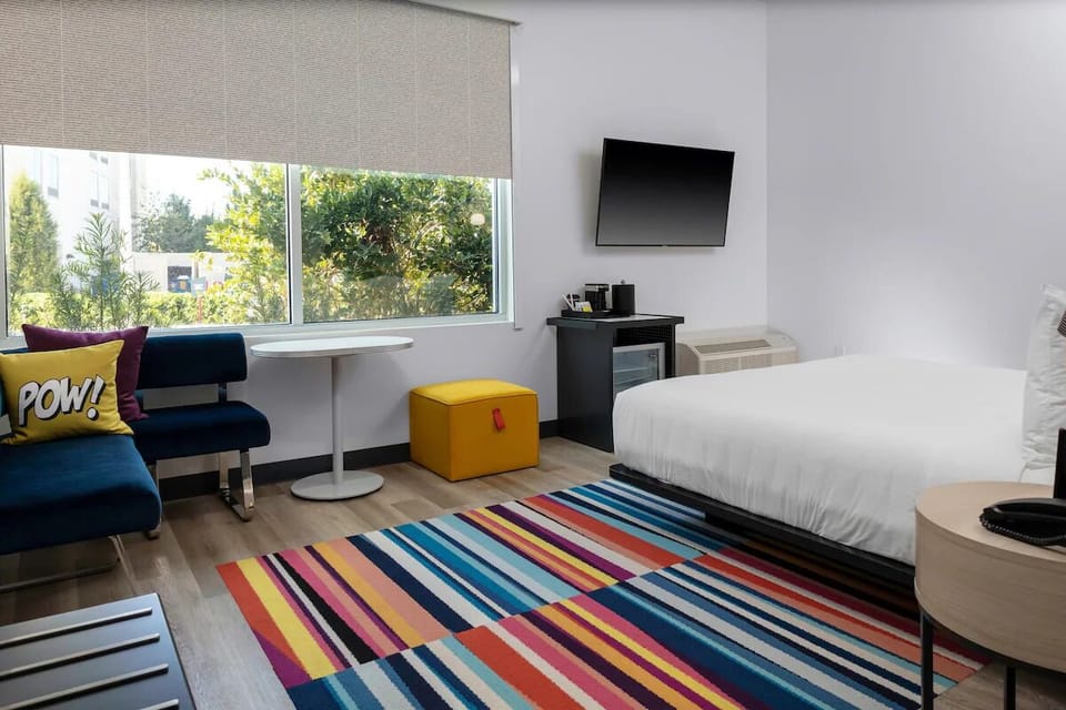 Wake up to sunshine, lounge seating, and colorful, playful accents.