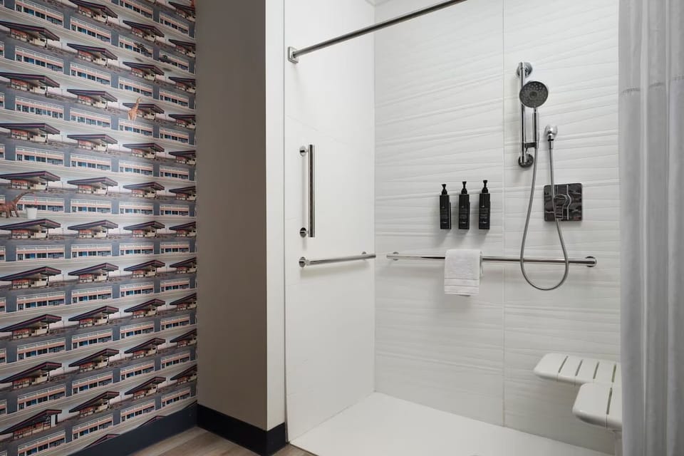 Step into a spotless walk-in shower with premium bath amenities.