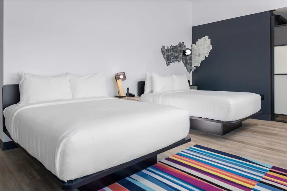 Sink into plush beds beside a vibrant, feel-good rug.
