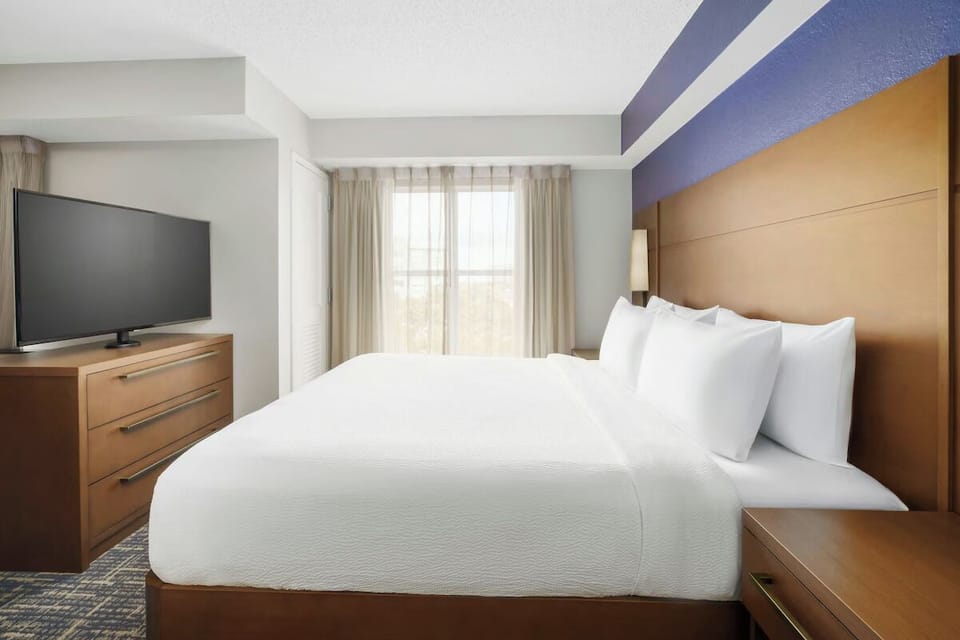 Unwind in a crisp king bed with calming daylight.