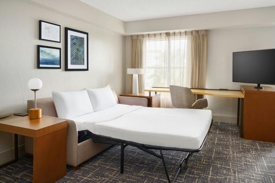 Unwind on crisp linens in a bright, calming sleep space.
