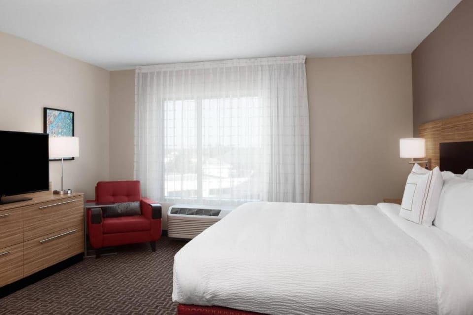 Wake to soft light in a crisp king bed.