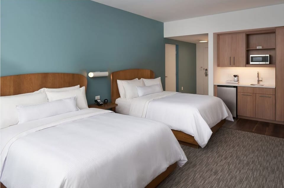 Settle in with two queens and convenient in-room kitchenette storage.
