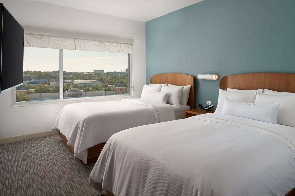 Wake up to soft daylight and views from two queen beds.