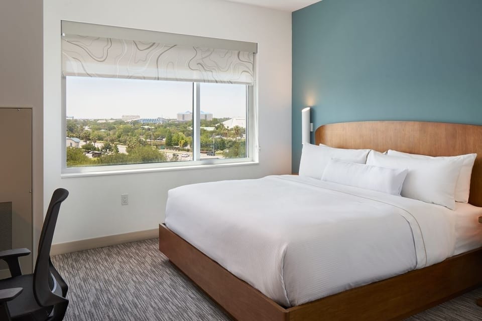 Unwind in a crisp king bed with bright city views.