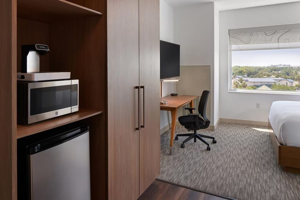 Settle in with handy kitchenette essentials and an easy work desk.