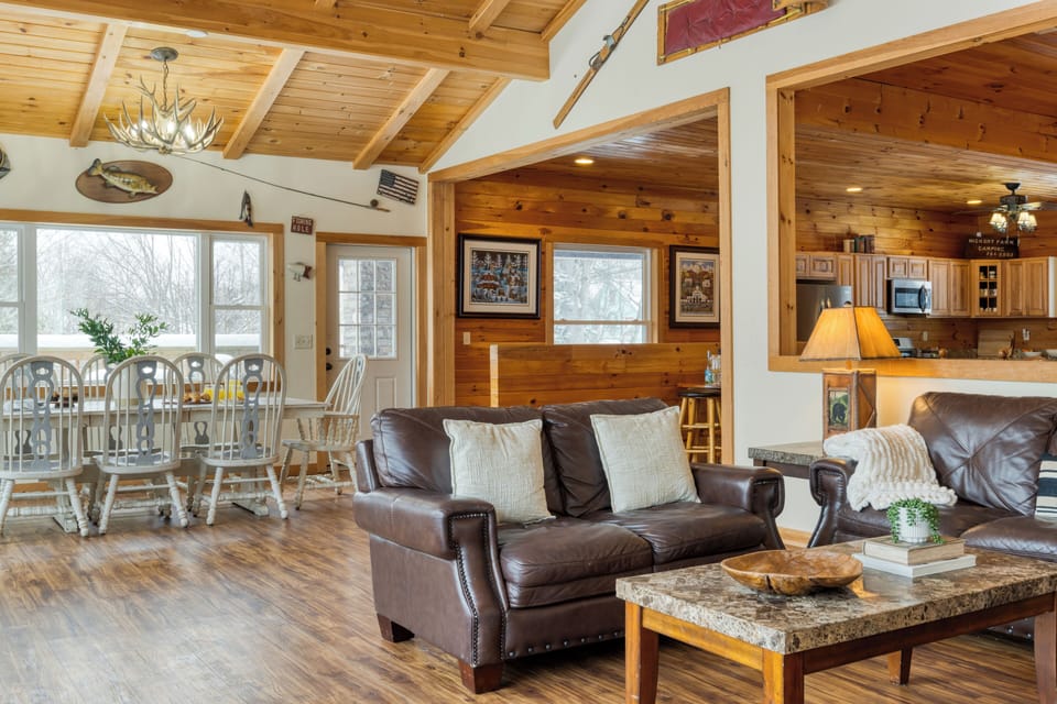 Cozy living room with rustic wood walls and natural light.