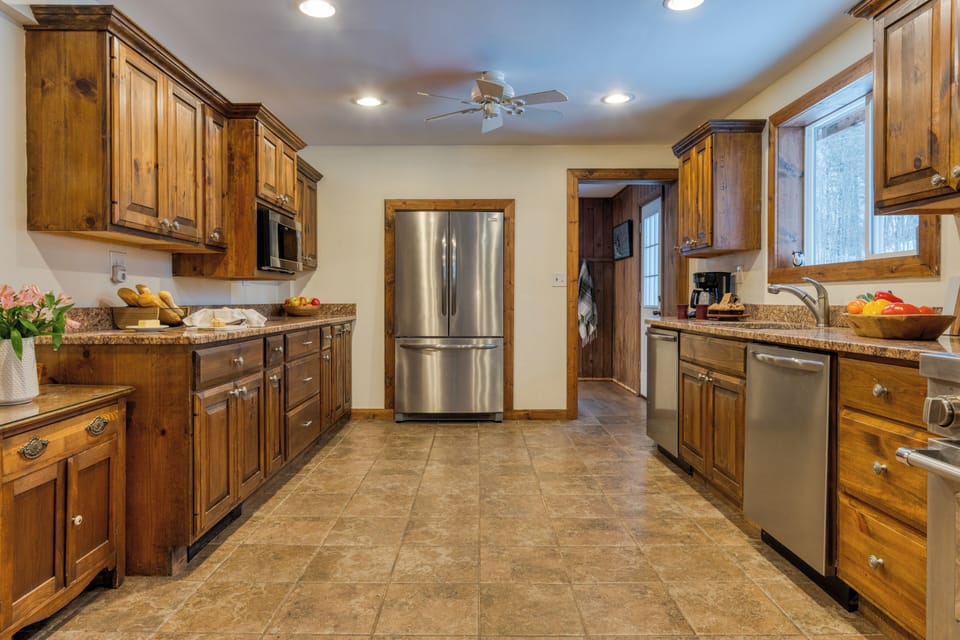 Wide kitchen view with island counter and modern appliances.