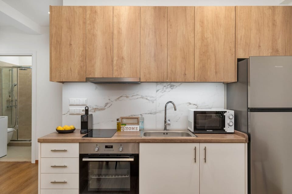Modern kitchen with oven, fridge, and essentials