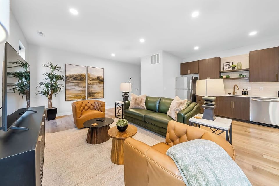 Unwind in this stylish open-concept space where leather seating meets modern kitchen convenience, perfect for your relaxing getaway.