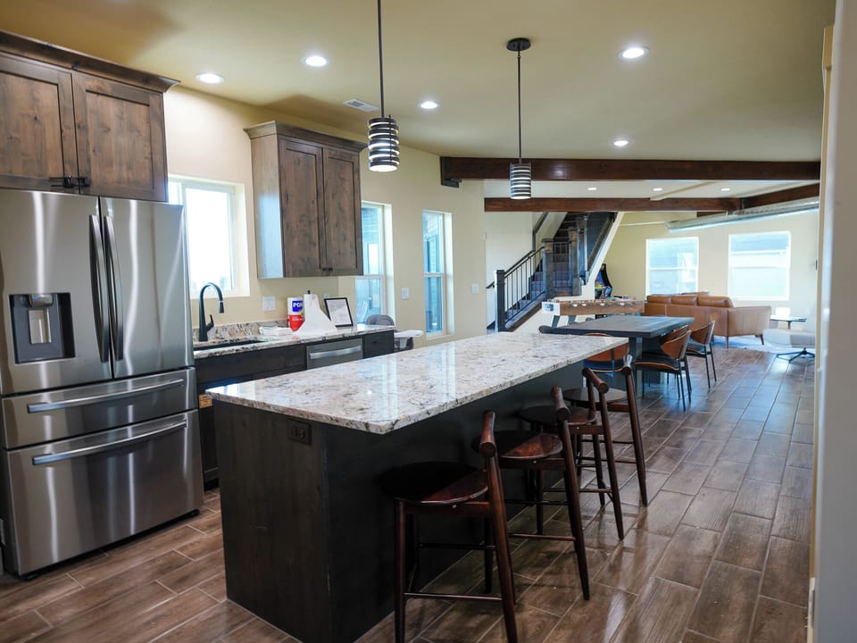 Your spacious kitchen features granite countertops, stainless steel appliances, and a breakfast bar where you can gather with loved ones.