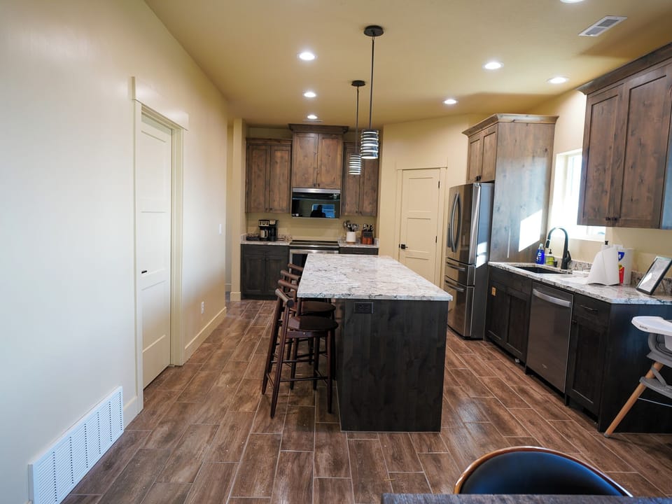 Your gourmet kitchen features granite countertops, stainless steel appliances, and a spacious island perfect for cooking memorable meals together.