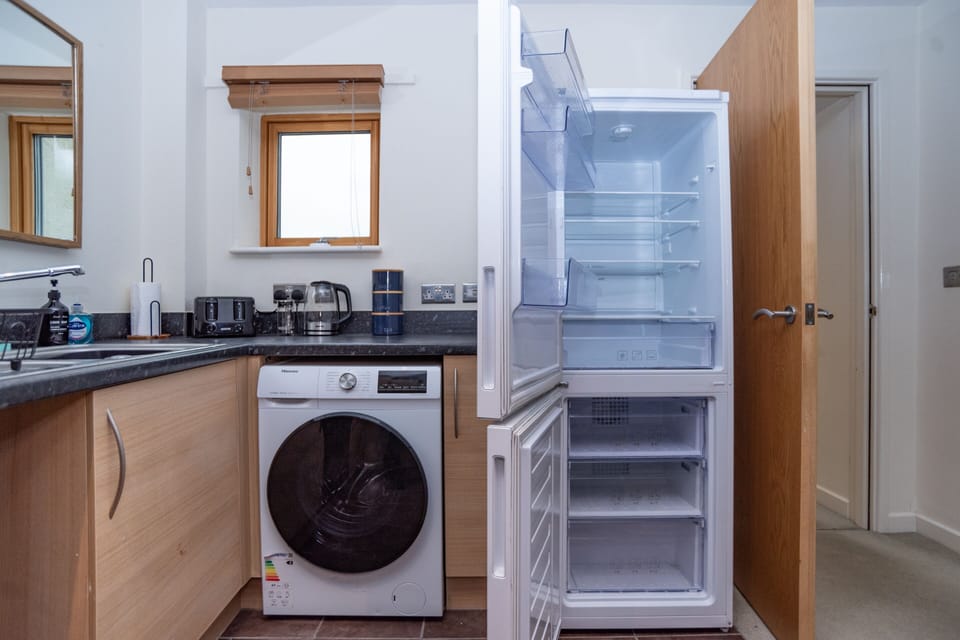 Practical home comforts including a washing machine and fridge freezer for a stress-free stay.