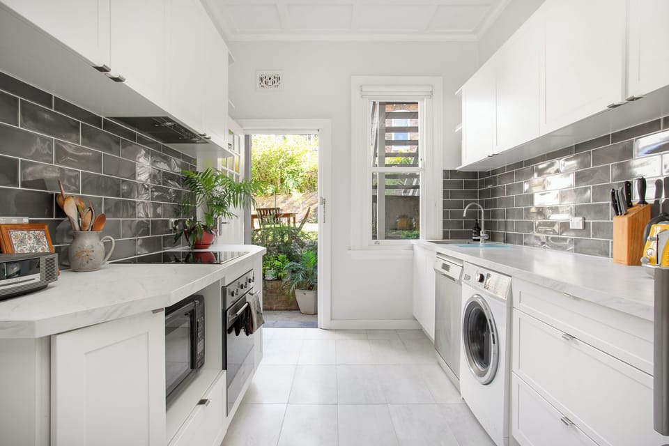 A gorgeous contemporary kitchen allows guests to cook a meal at home and includes an internal washing machine for your everyday convenience.