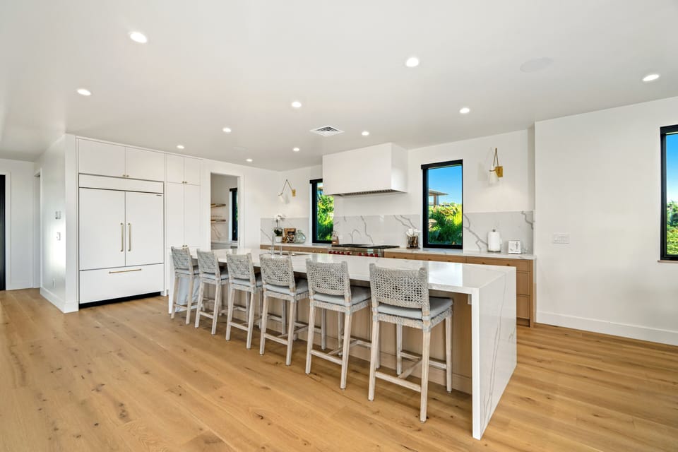 Gather with friends at your spacious kitchen island, where modern elegance meets comfort in this bright, open kitchen.