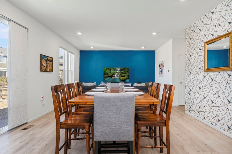 Gather around your spacious dining table where modern comfort meets warm wood tones, creating the perfect spot for memorable meals together.