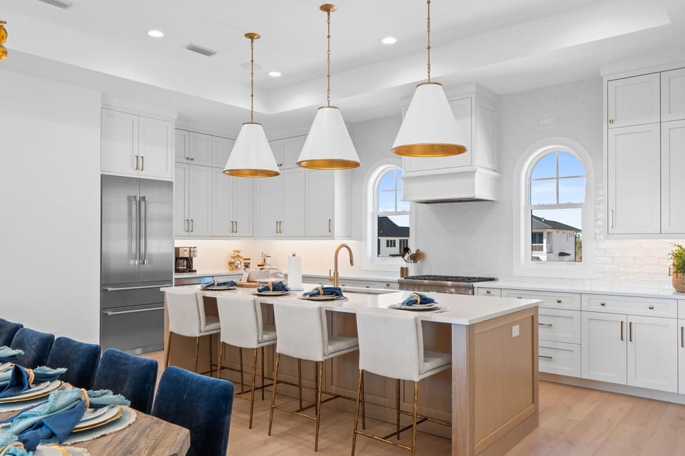 Cook memorable meals in your stunning gourmet kitchen, featuring elegant pendant lighting and premium appliances.