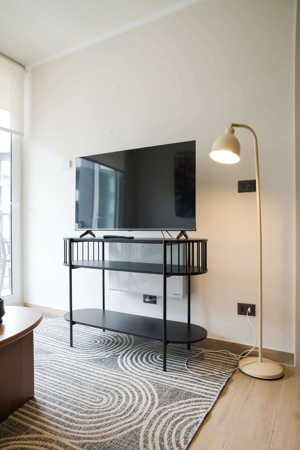 Cozy living area with a sleek TV setup and stylish lighting, perfect for relaxing after a day of exploring.