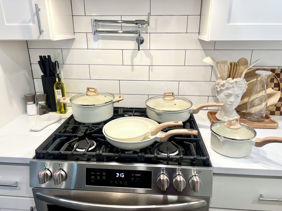 Chef-ready kitchen with gas range, pot filler, and complete cookware set