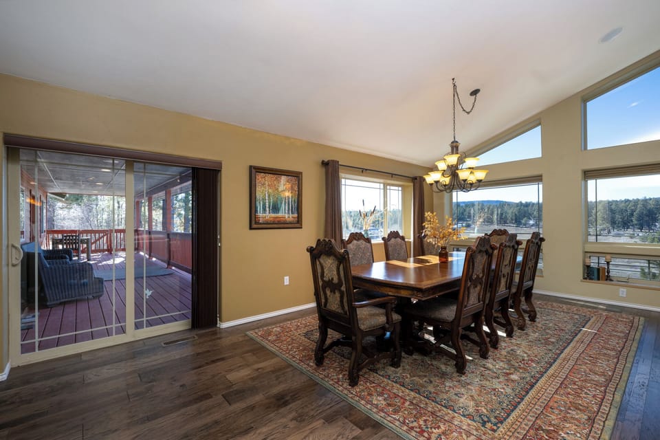Gather around your elegant dining table while enjoying stunning mountain views through floor-to-ceiling windows and easy access to your private deck.