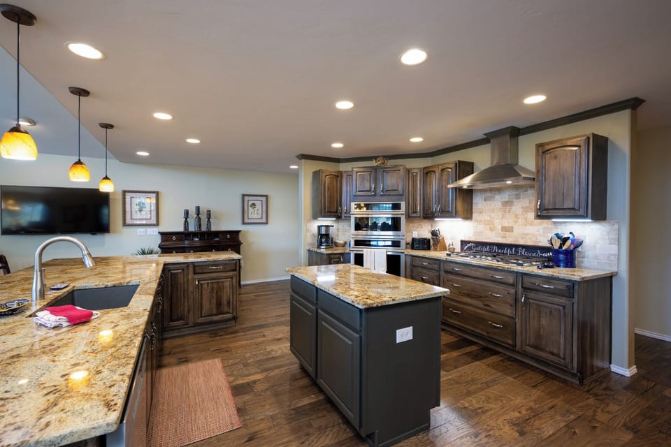 Your gourmet kitchen awaits with granite countertops, stainless steel appliances, and an island perfect for cooking memorable meals together.
