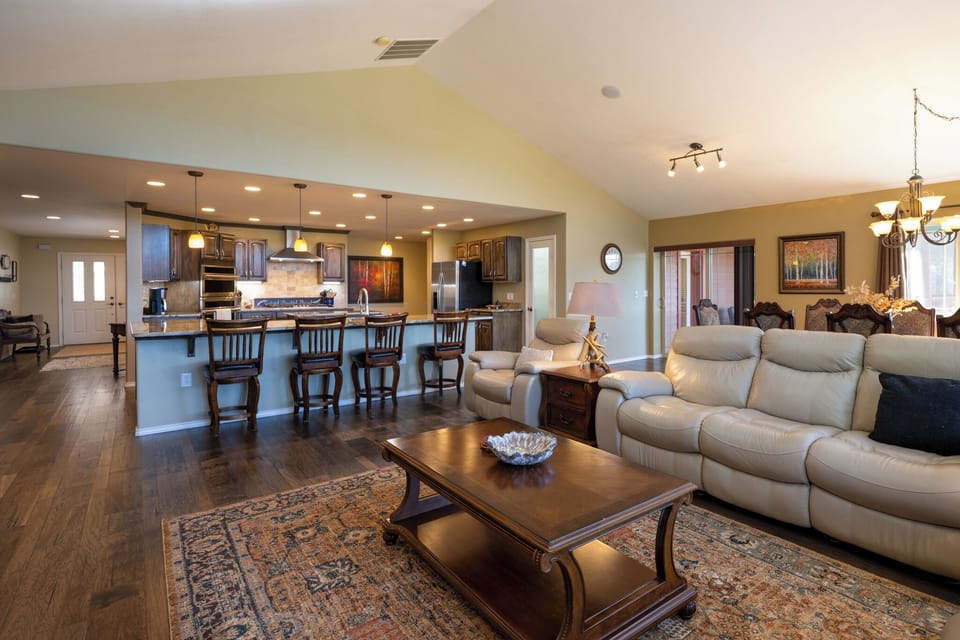 Relax in your spacious open-concept living area, where plush seating flows seamlessly into a gourmet kitchen perfect for entertaining.