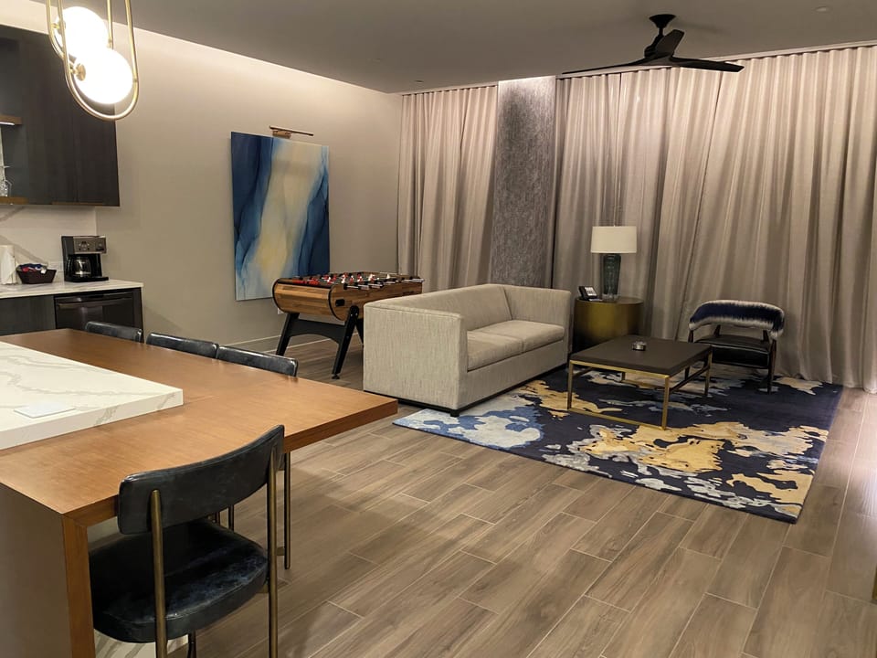 Presidential 1bdrm living room with TV and foosball table