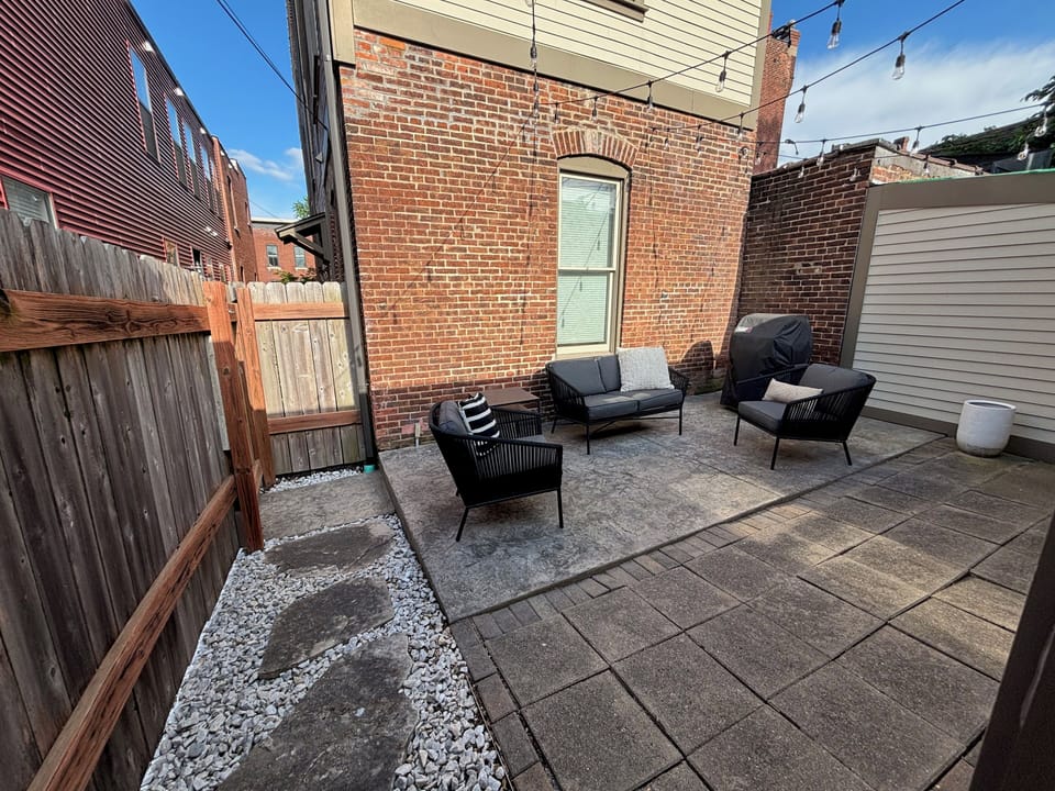 Back patio under twinkle lights with included grill