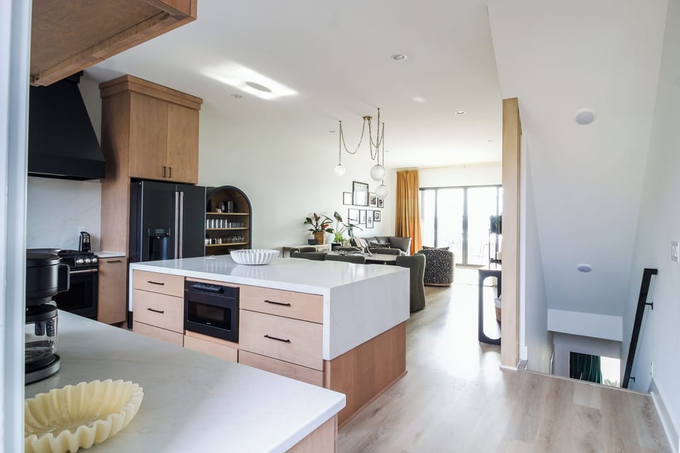 Open-concept kitchen flowing into the dining and main living area