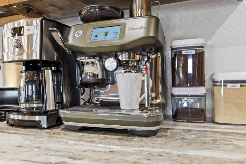 Curated coffee station with an espresso machine, traditional coffee maker, and quality supplies—designed to elevate your morning routine during your stay.