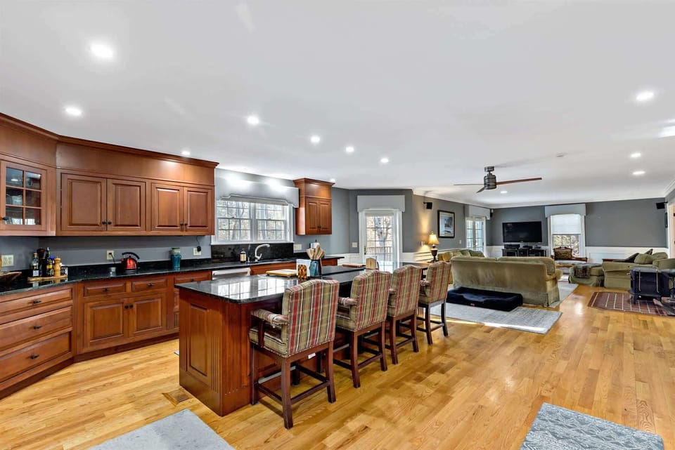Open-concept kitchen flows into the living area for effortless entertaining, a great layout for multi-family Cape Cod stays.